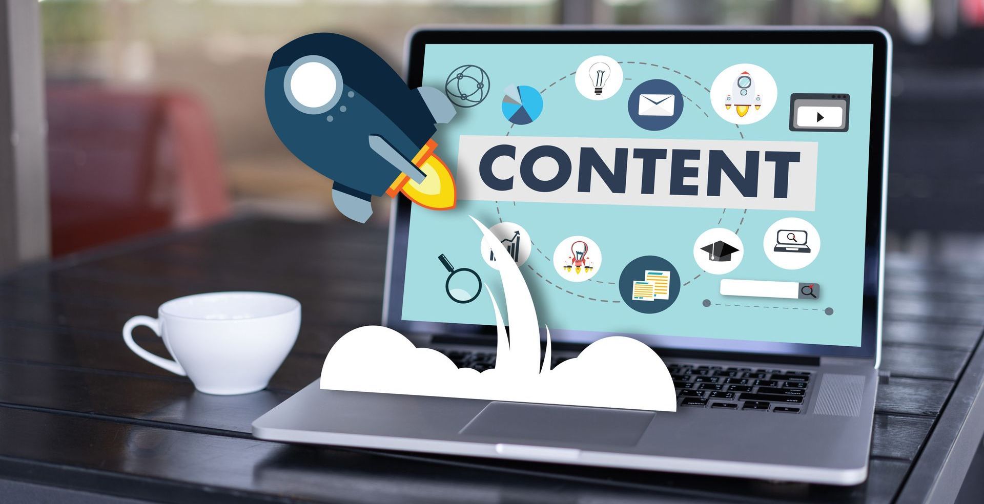 leptop open on a table with content rocket graphic flying out
