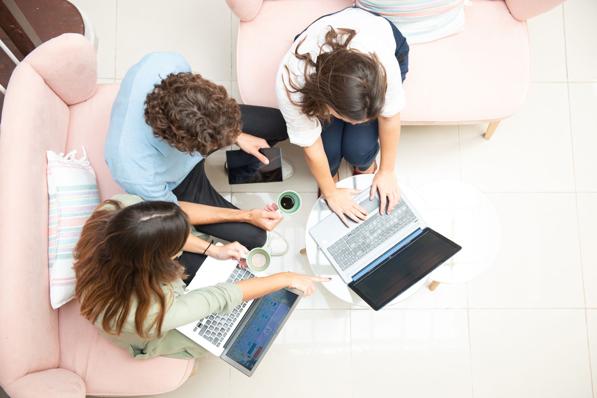 Bird's eye view of group sitting around with laptops open