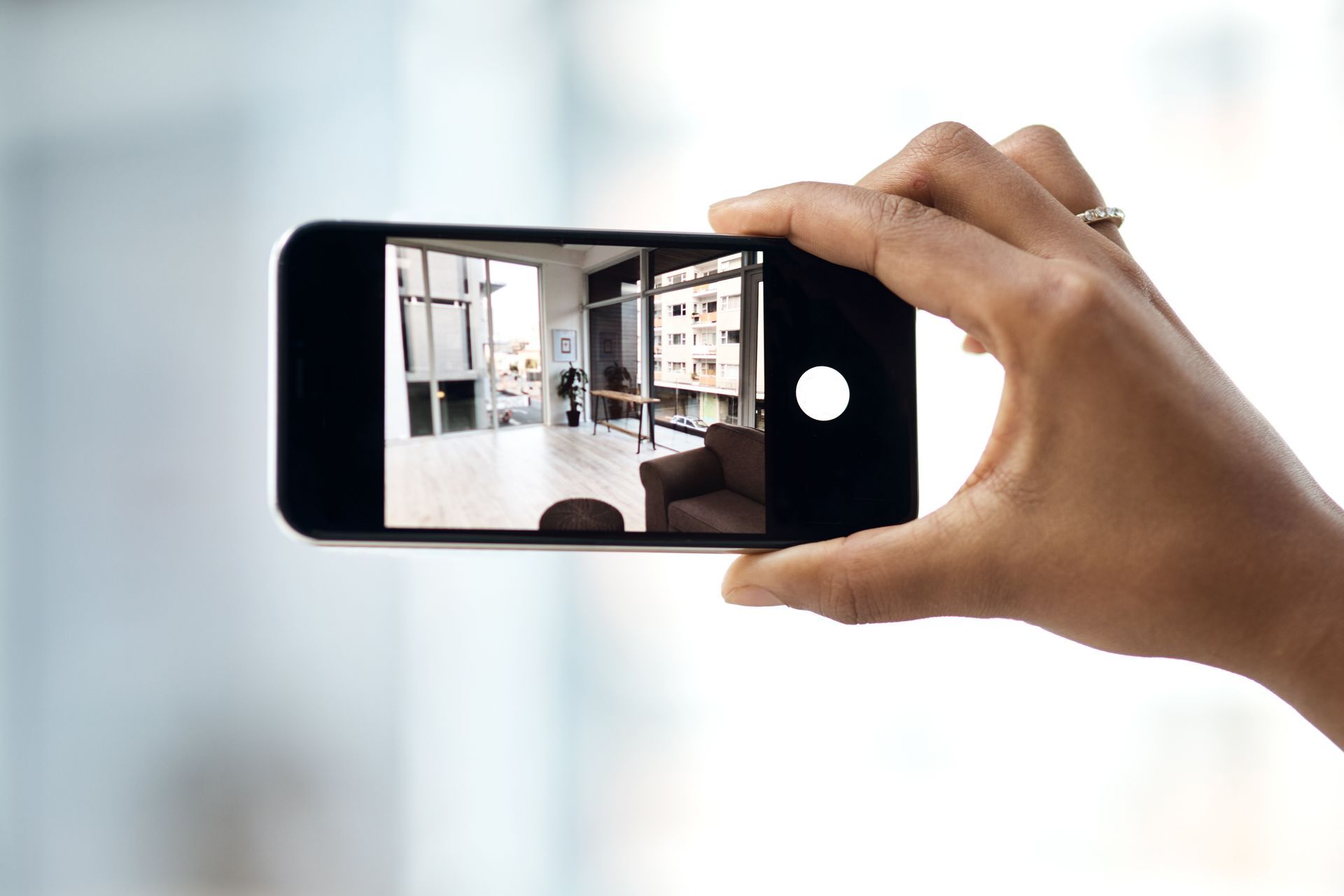 Hand capturing interior design space on an iPhone