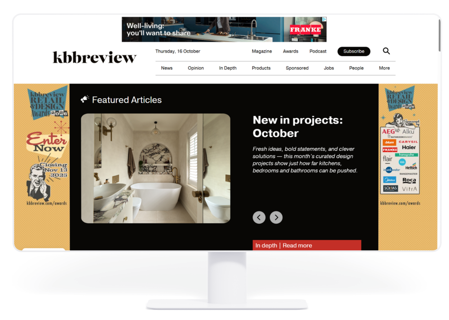 Website homepage on a desktop monitor, featuring a black-and-white editorial layout with a featured article panel and banners.