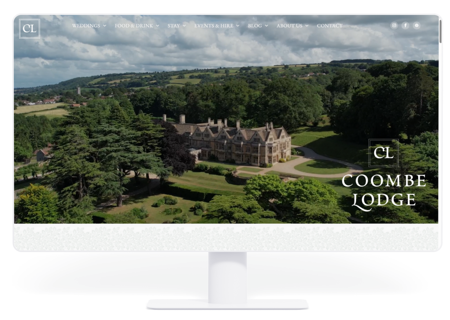 Coombe Lodge website, showing an aerial view of a stately home nestled in a green landscape.