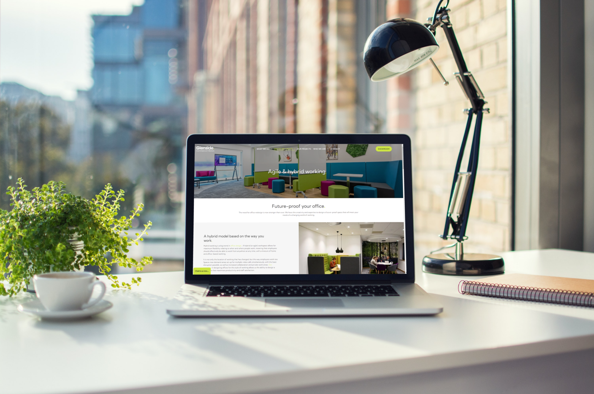 A laptop computer is open to a website on a desk.