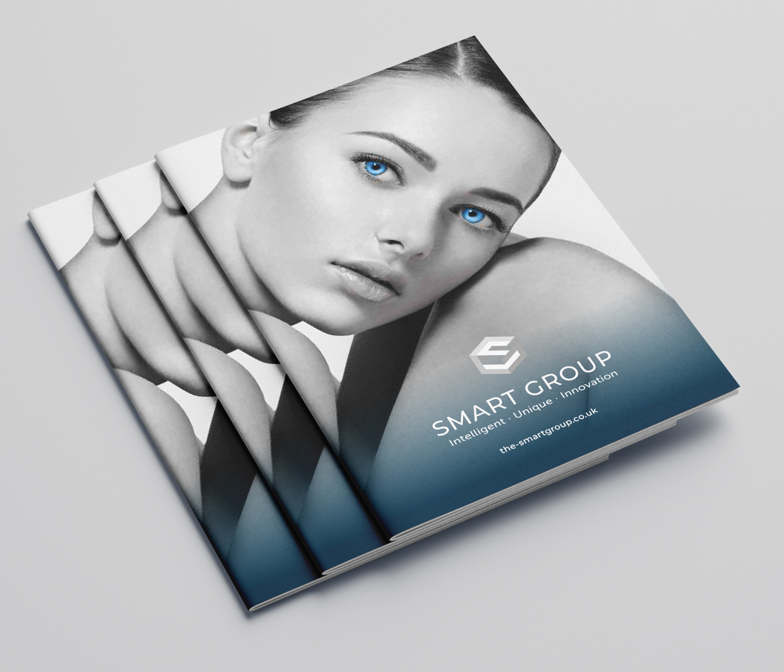 Brochure with woman's face and blue eyes; "Smart Group" logo and tagline.