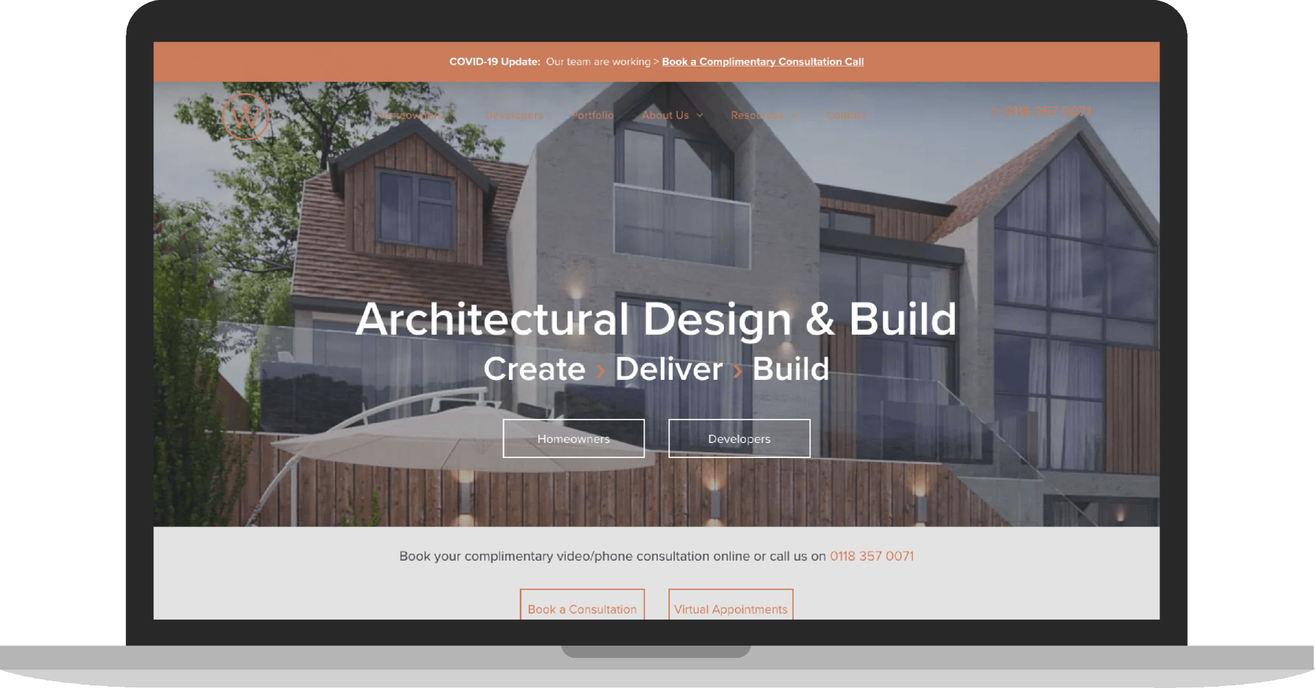 A laptop computer is open to a website for architectural design and build.