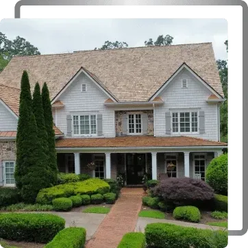 Large white two-story house with a front porch, brick walkway, and manicured shrubs