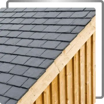 Roof with gray shingles and exposed wooden framing on a house gable.
