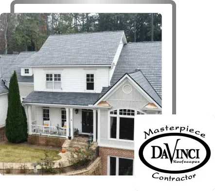 White house with gray roof and front porch, labeled “Masterpieces DaVinci Contractor” in the corner