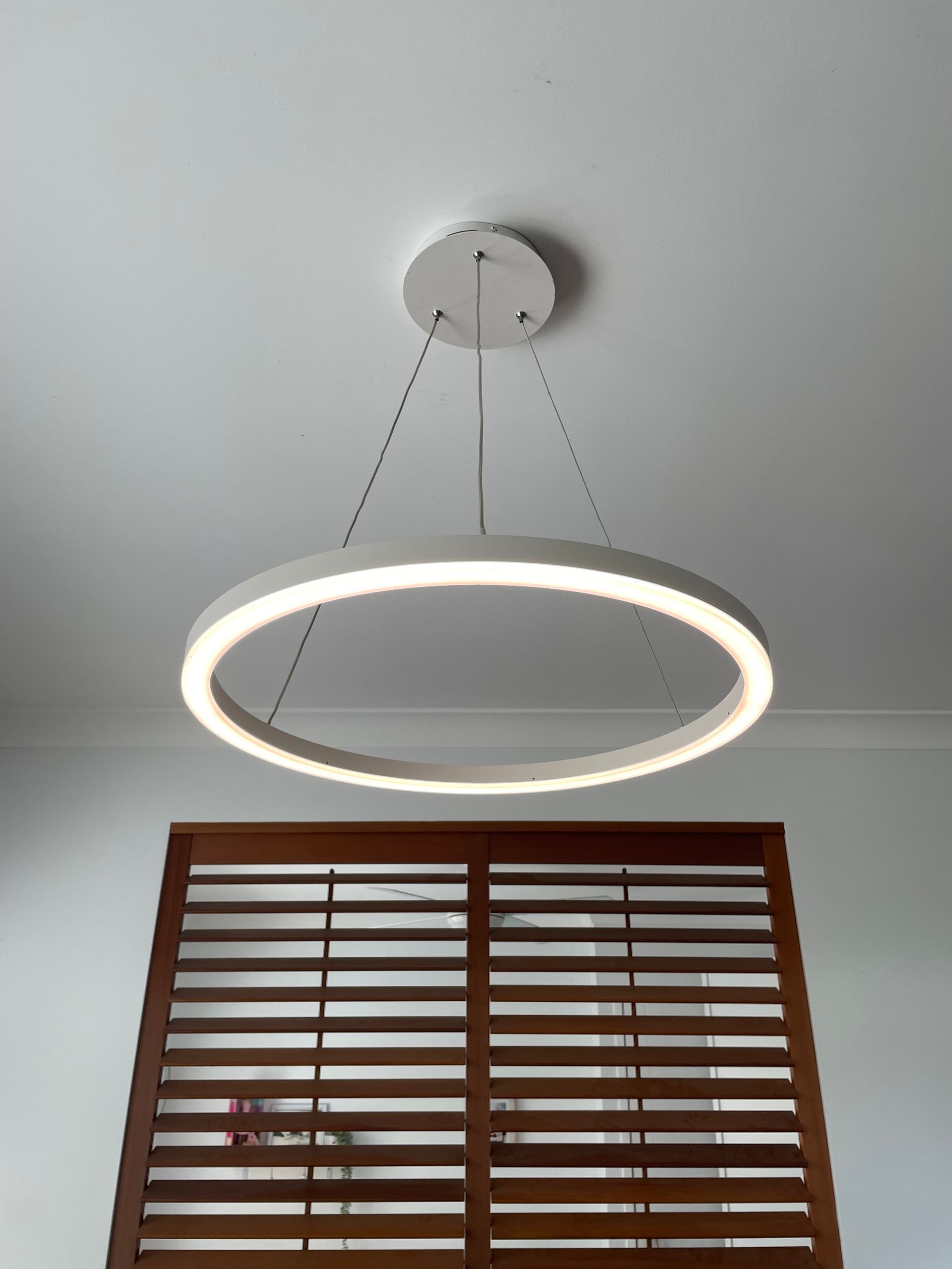 Circular, Illuminated Pendant Light Hanging Above — Stewys in Casuarina, NSW
