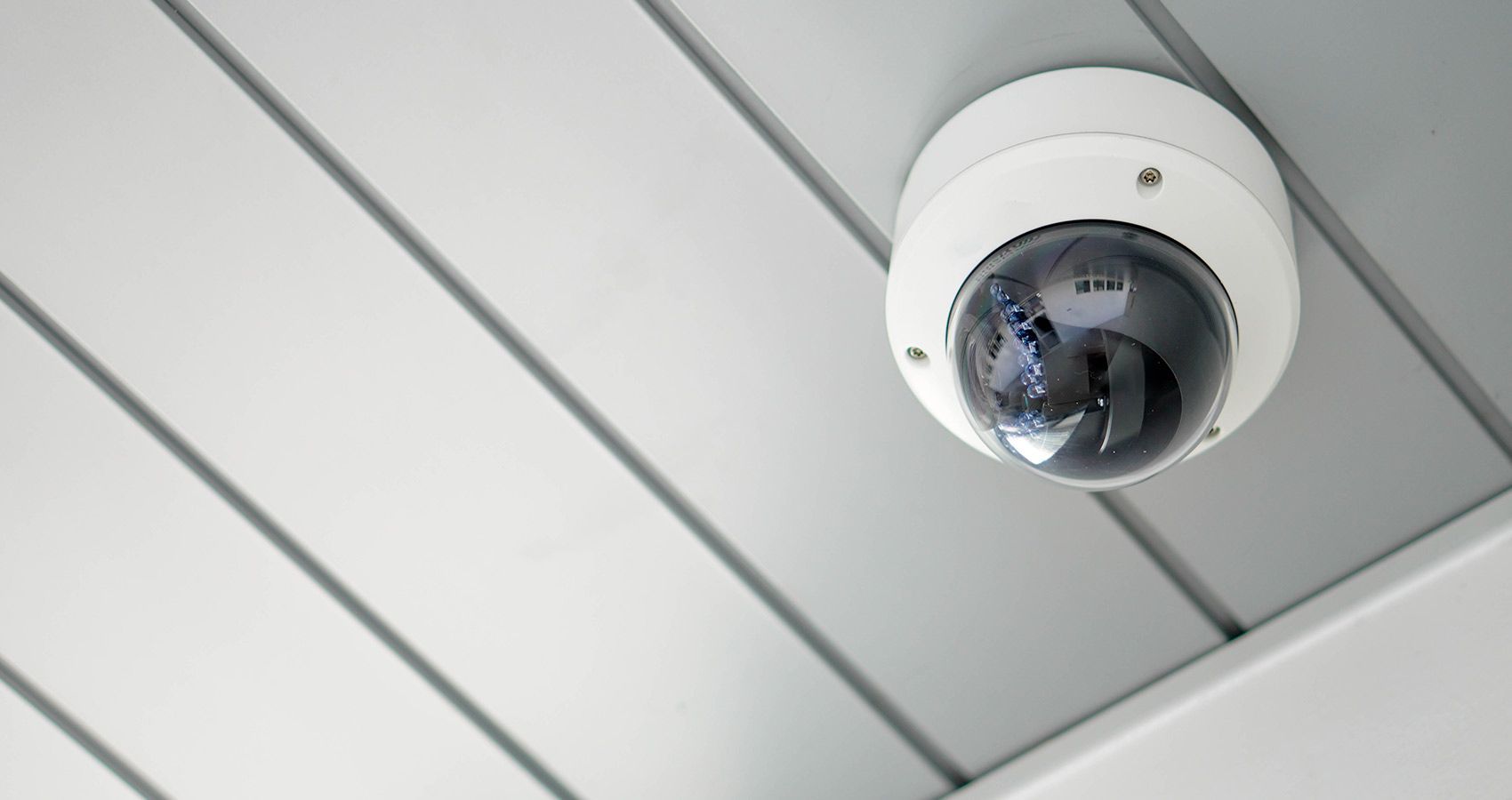 White Dome Security Camera Mounted On A Light Gray Ceiling, Angled View — Stewys in Tweed Heads, NSW