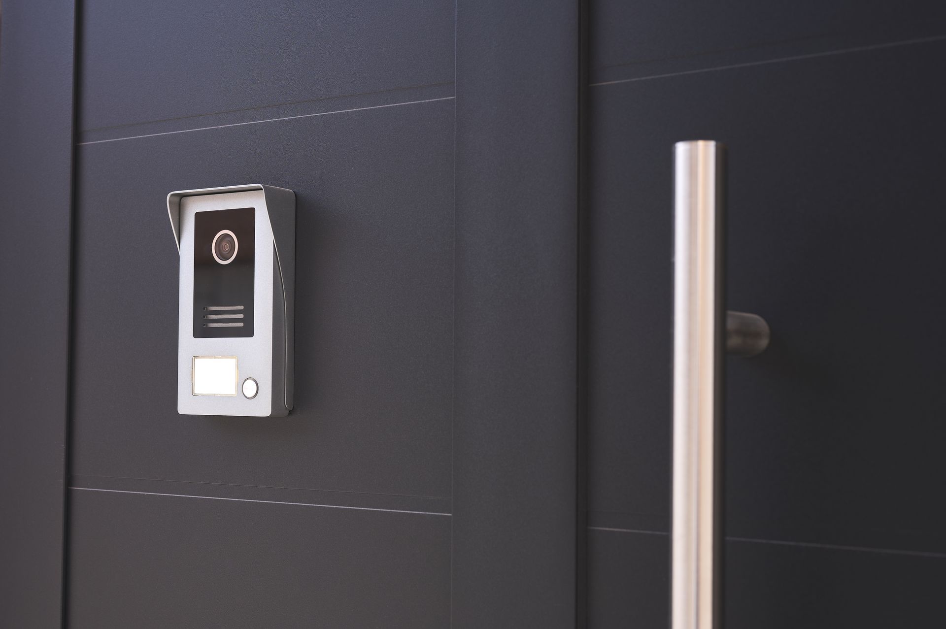 Gray Intercom On A Dark Gray Door Next To A Silver Handle — Stewys in Tweed Heads, NSW