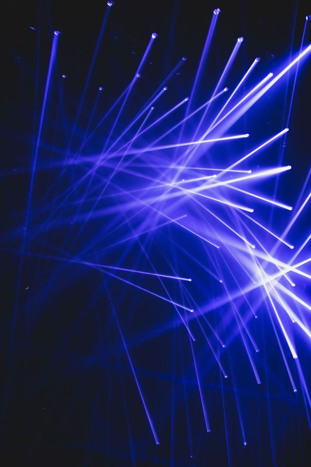 Abstract purple and blue laser beams — Laser Tag event preview.