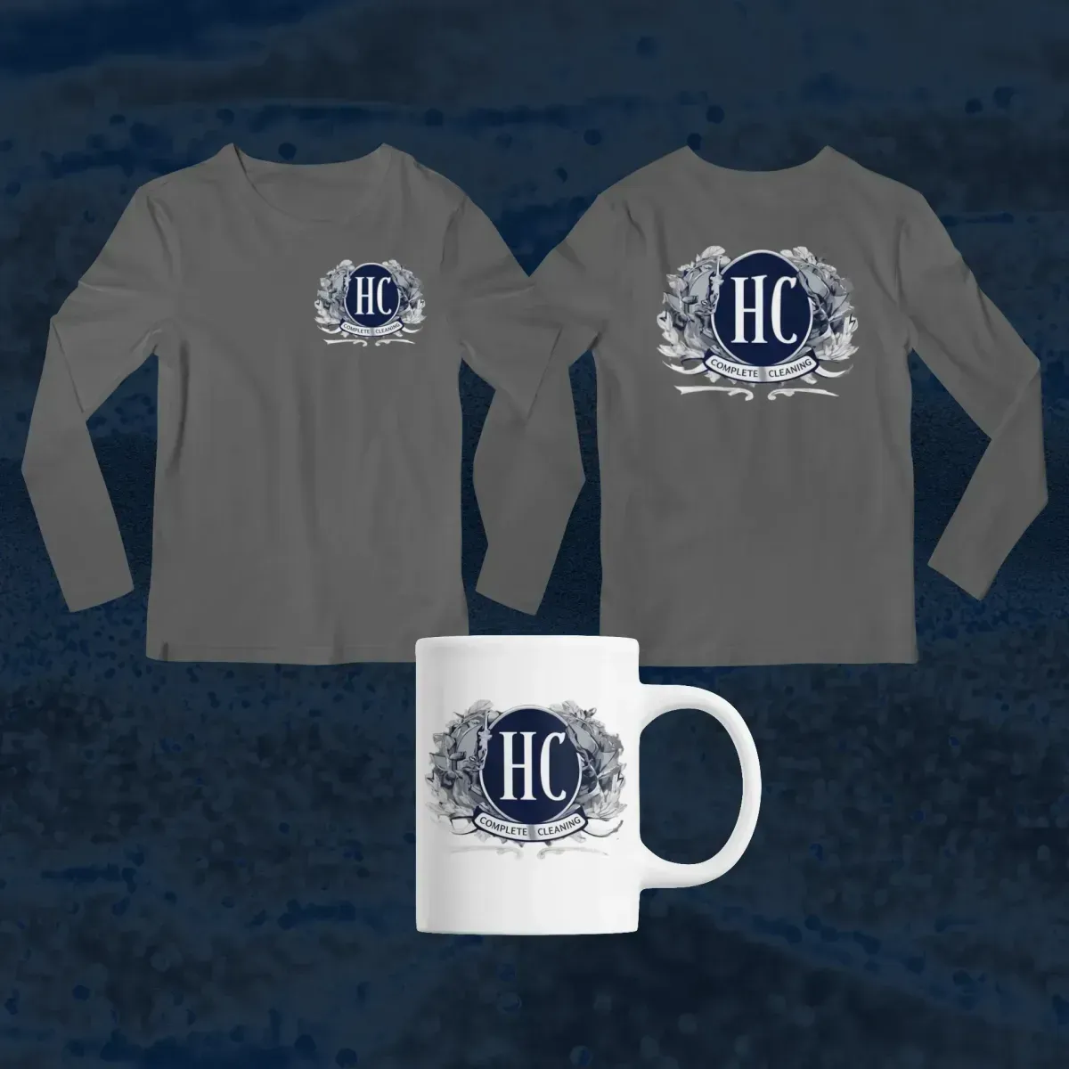 Gray long-sleeve shirts and a white mug with a navy HC logo on a dark blue background