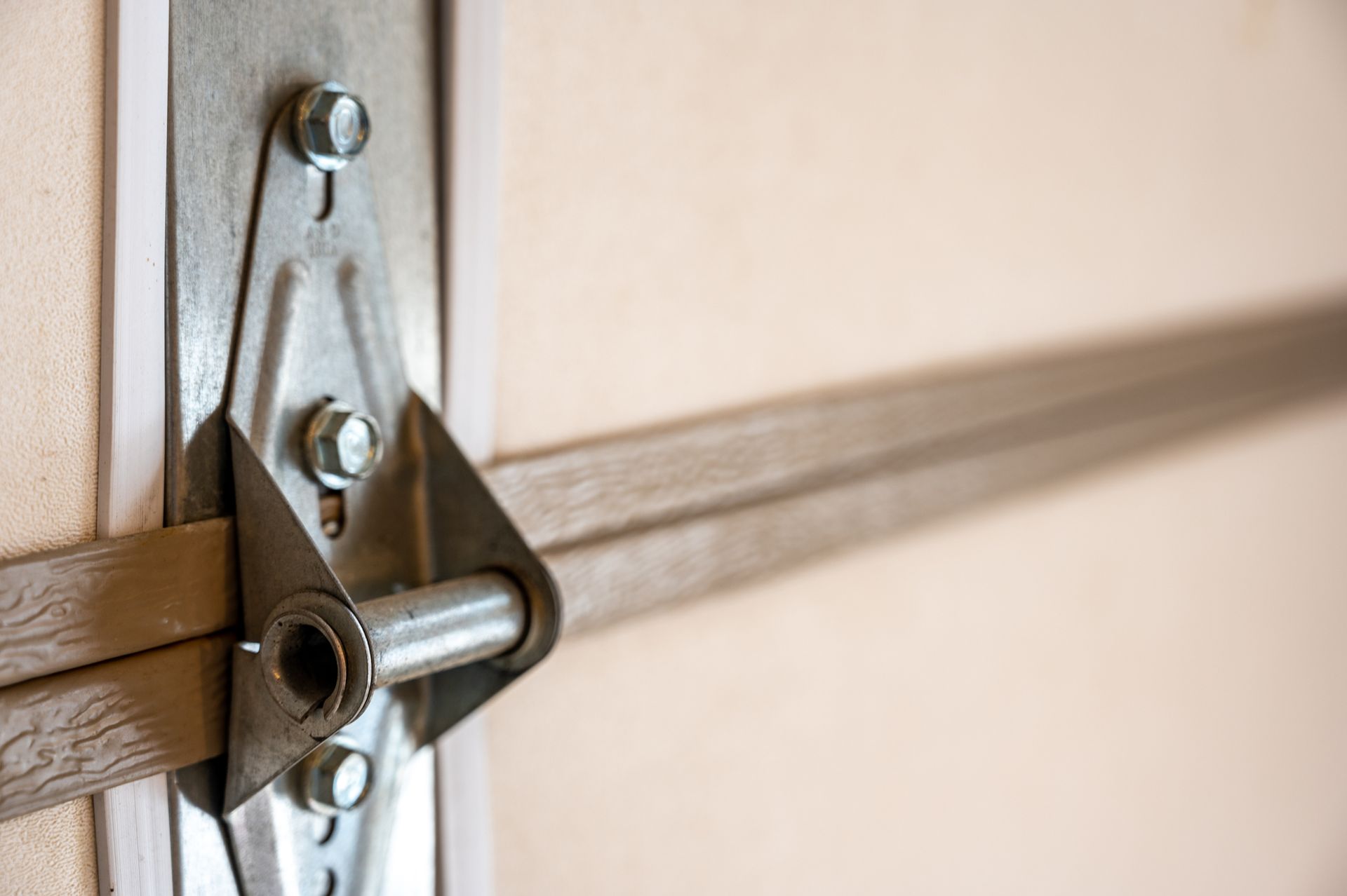 A close up of a metal bracket on a garage door.