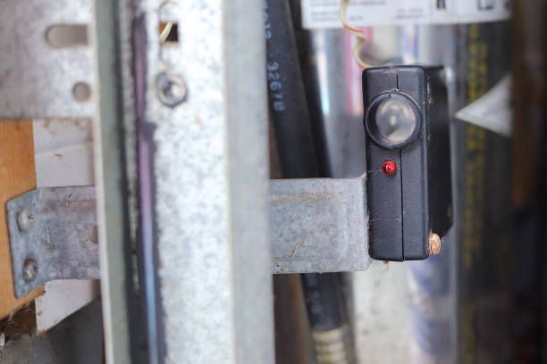 A close up of a door with a red light on it.