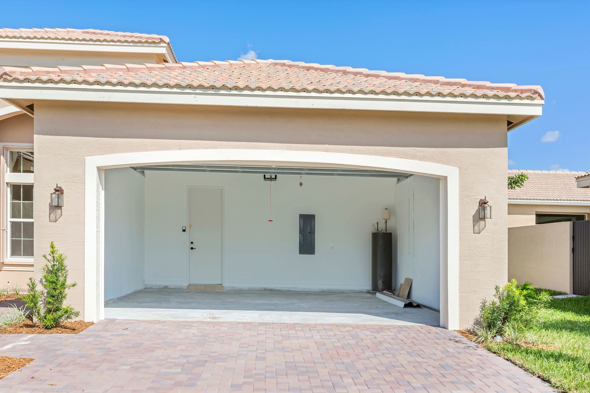 A house with a garage with the door open.