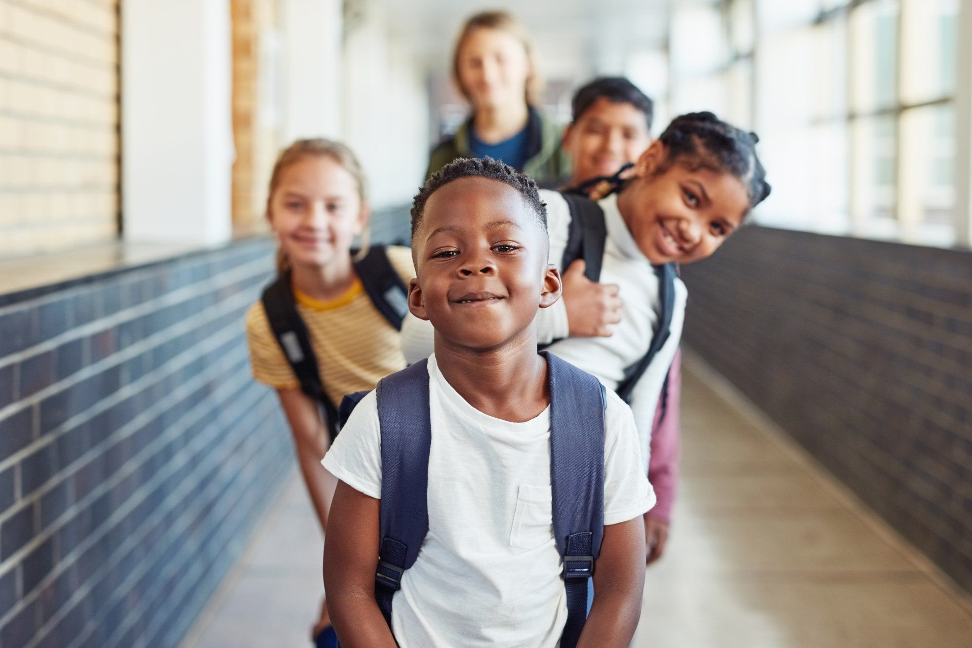 Children Standing in Line Waiting for Boarding School Bus — Ferguson, MO — Lil Smarties Learning Center Children Standing in Line Waiting for Boarding School Bus — Ferguson, MO — Lil Smarties Learning Center