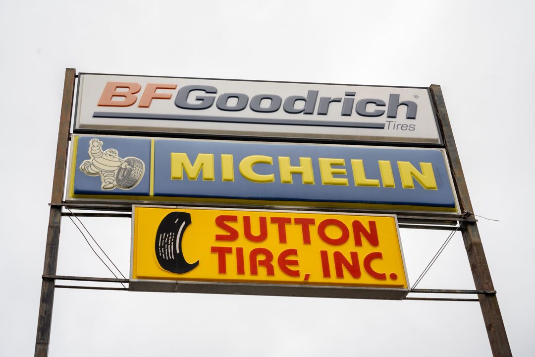 Tall roadside sign for BFGoodrich, Michelin, and Sutton Tire, Inc.