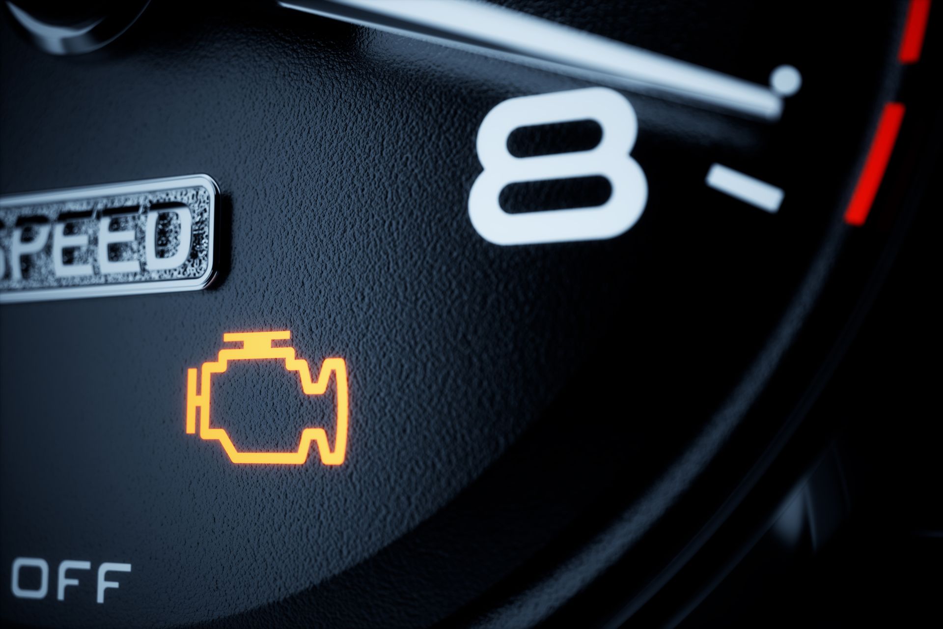 Close-up of a car dashboard with an illuminated yellow check engine warning light
