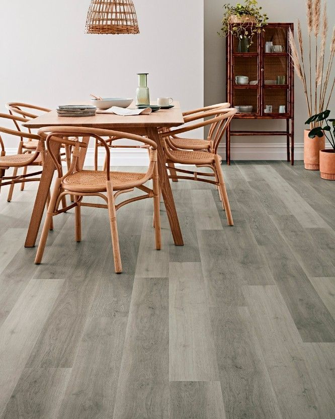 A Dining Room With a Table and Chairs on a Wooden Floor — Hoppens Floorworld in Atherton, QLD