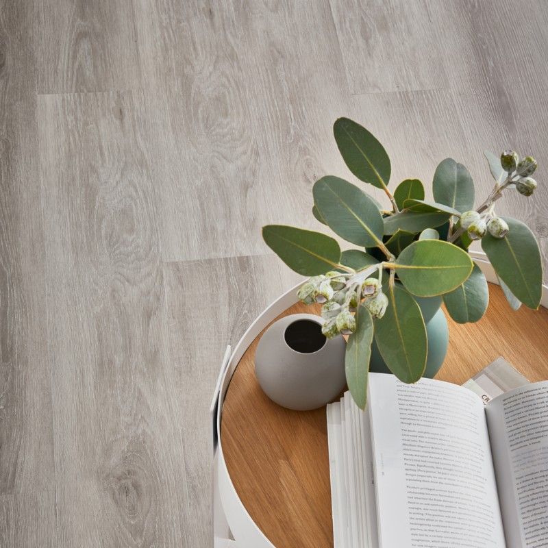 A Table With a Vase of Flowers and a Book on It — Hoppens Floorworld in Manunda, QLD