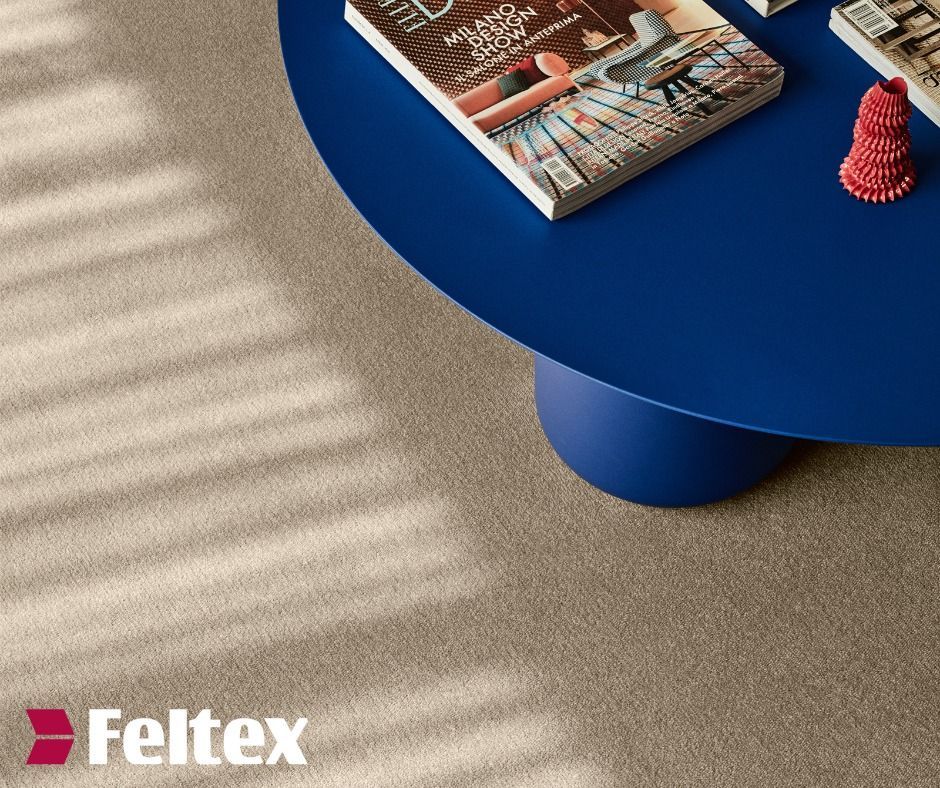 Close-up of a Beige Carpet With a Royal Blue Round Coffee Table — Hoppens Floorworld in Mareeba, QLD