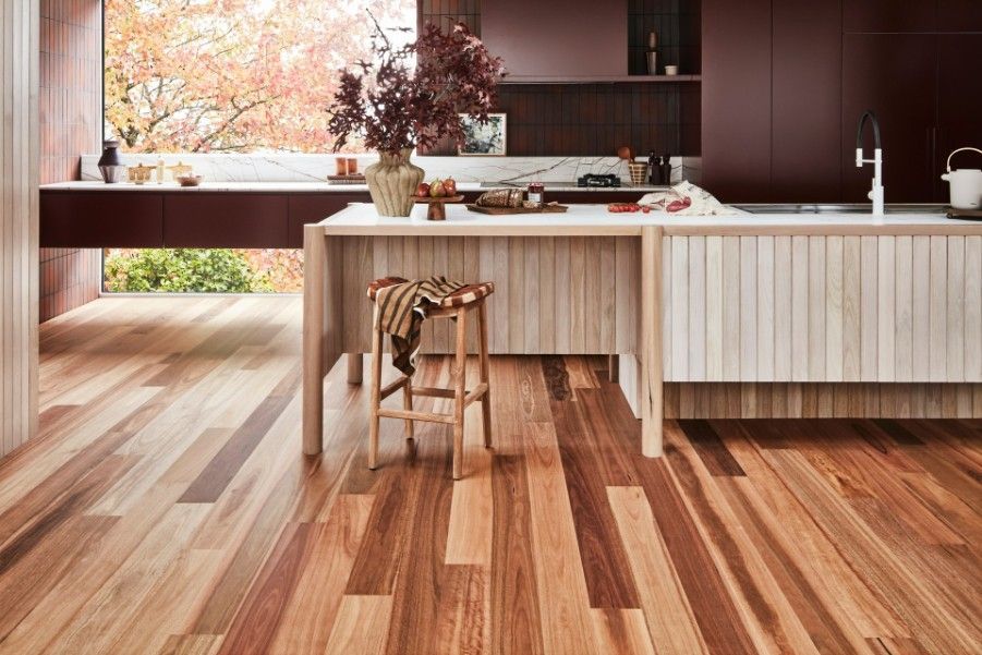 A Kitchen With Hardwood Floors and a Large Island — Hoppens Floorworld in Manunda, QLD