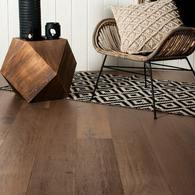 A Living Room With a Wicker Chair and a Wooden Table — Hoppens Floorworld in Palm Cove, QLD