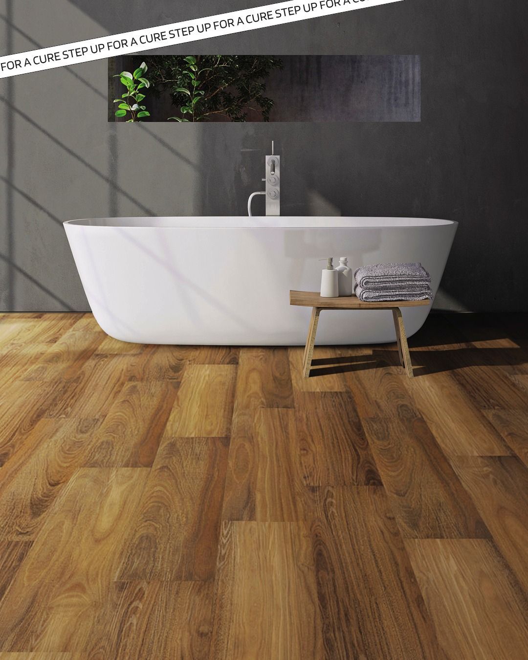 Bathroom with hardwood floors, a white soaking tub, and a small wooden stool with towels and toiletries.