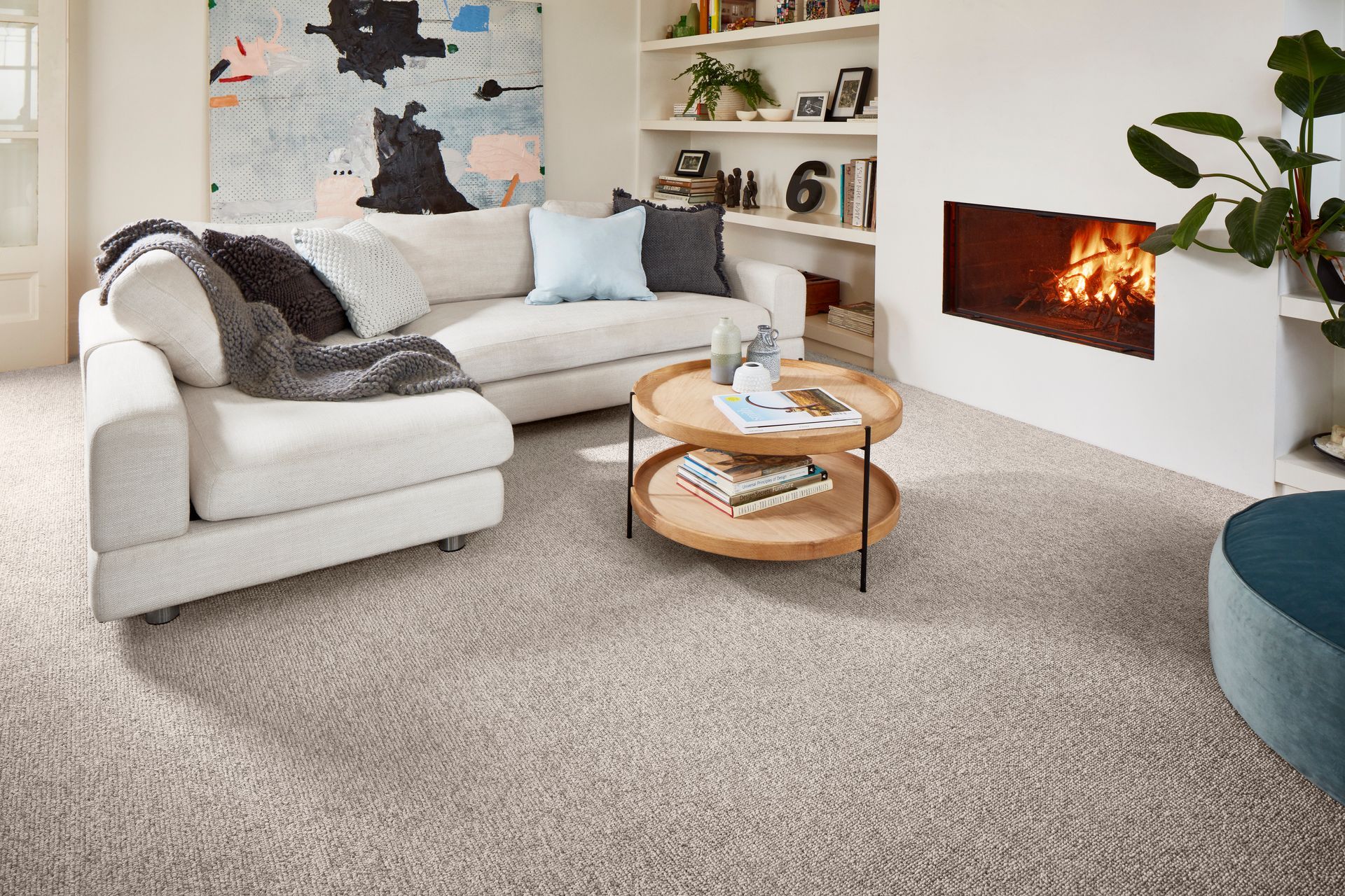 Cozy Living Room With a Sectional Sofa, a Fireplace, and a Patterned Carpet — Hoppens Floorworld in Mareeba, QLD