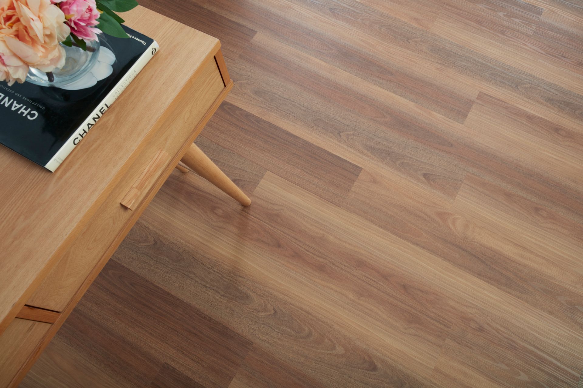 Wooden Table With Book and Flowers on Light Brown Wooden Floor — Hoppens Floorworld in Mooroobool, QLD
