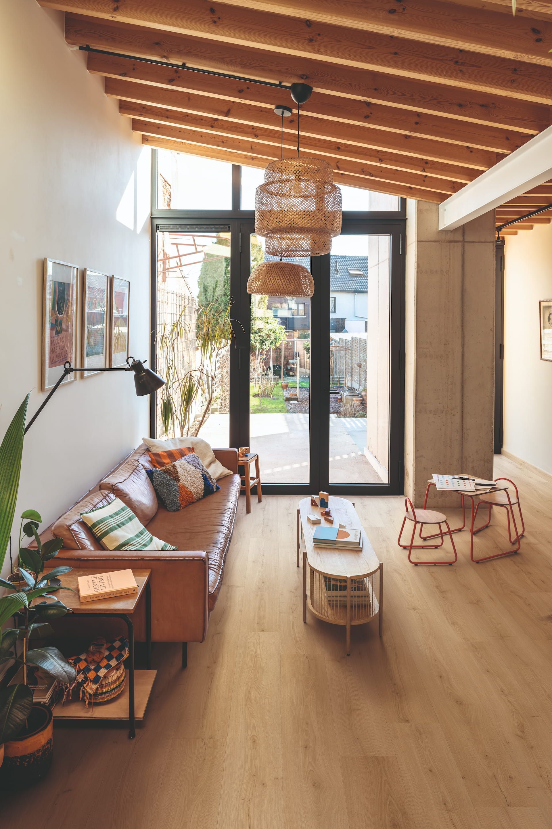 Living Room With Brown Leather Sofa, Open to Backyard, Wooden Beams, Natural Light — Hoppens Floorworld in Palm Cove, QLD