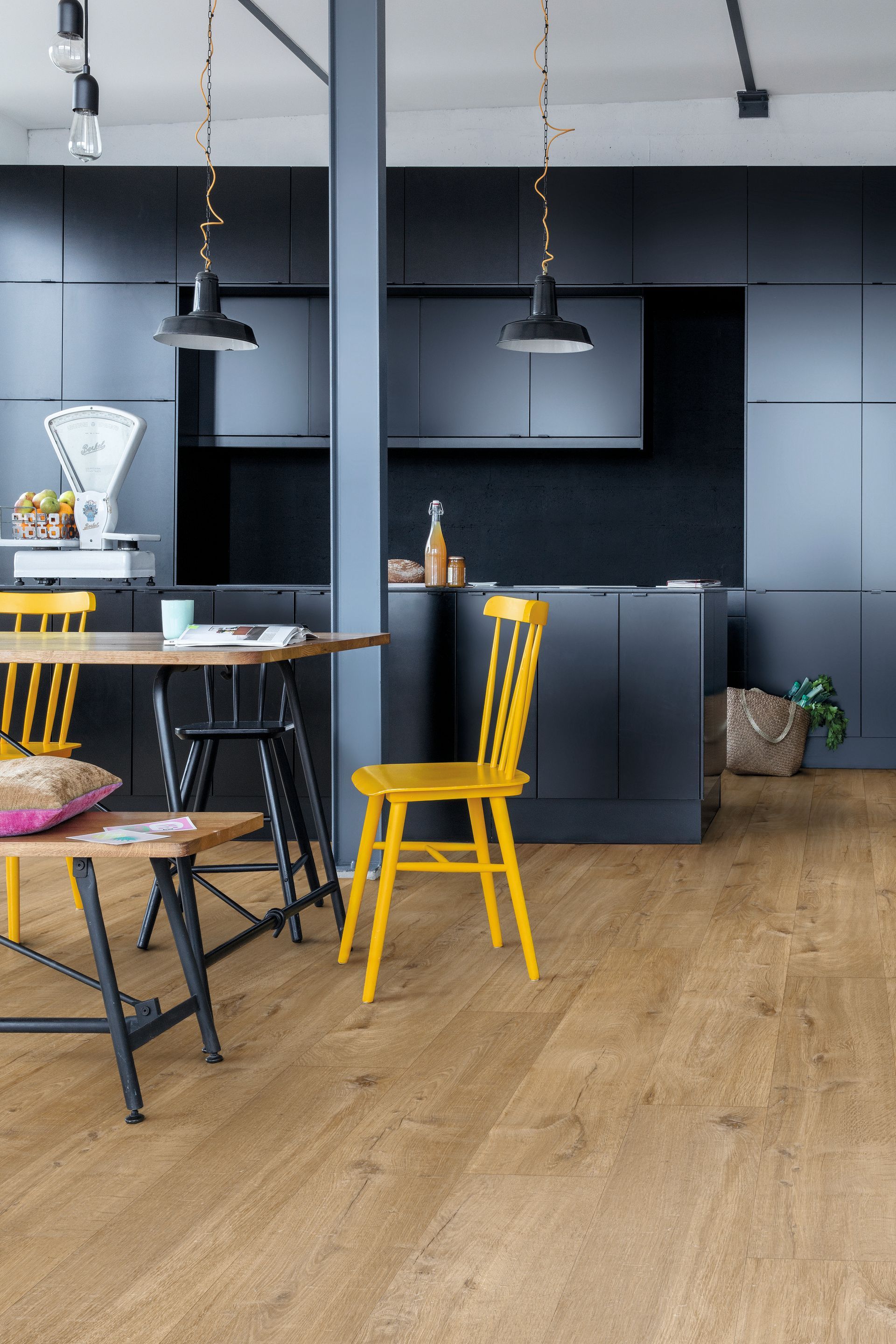 Modern Kitchen With Dark Blue Cabinetry, Wood Flooring, and Chairs at Table — Hoppens Floorworld in Mareeba, QLD