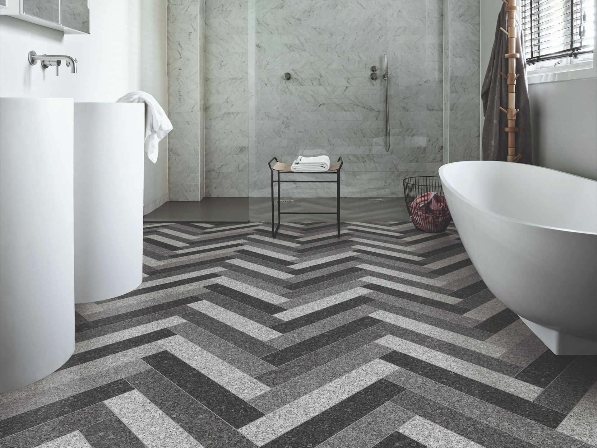 Bathroom With Chevron-patterned Floor, White Fixtures, Marble Walls, and a Shower — Hoppens Floorworld in Mooroobool, QLD