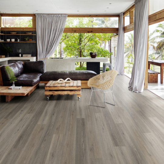 A Living Room With Hardwood Floors and a Couch — Hoppens Floorworld in Manunda, QLD