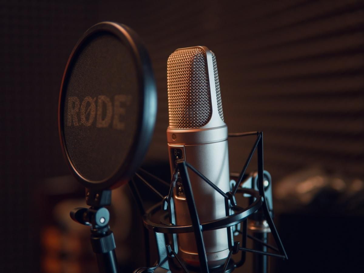 A close up of a rode microphone in a recording studio