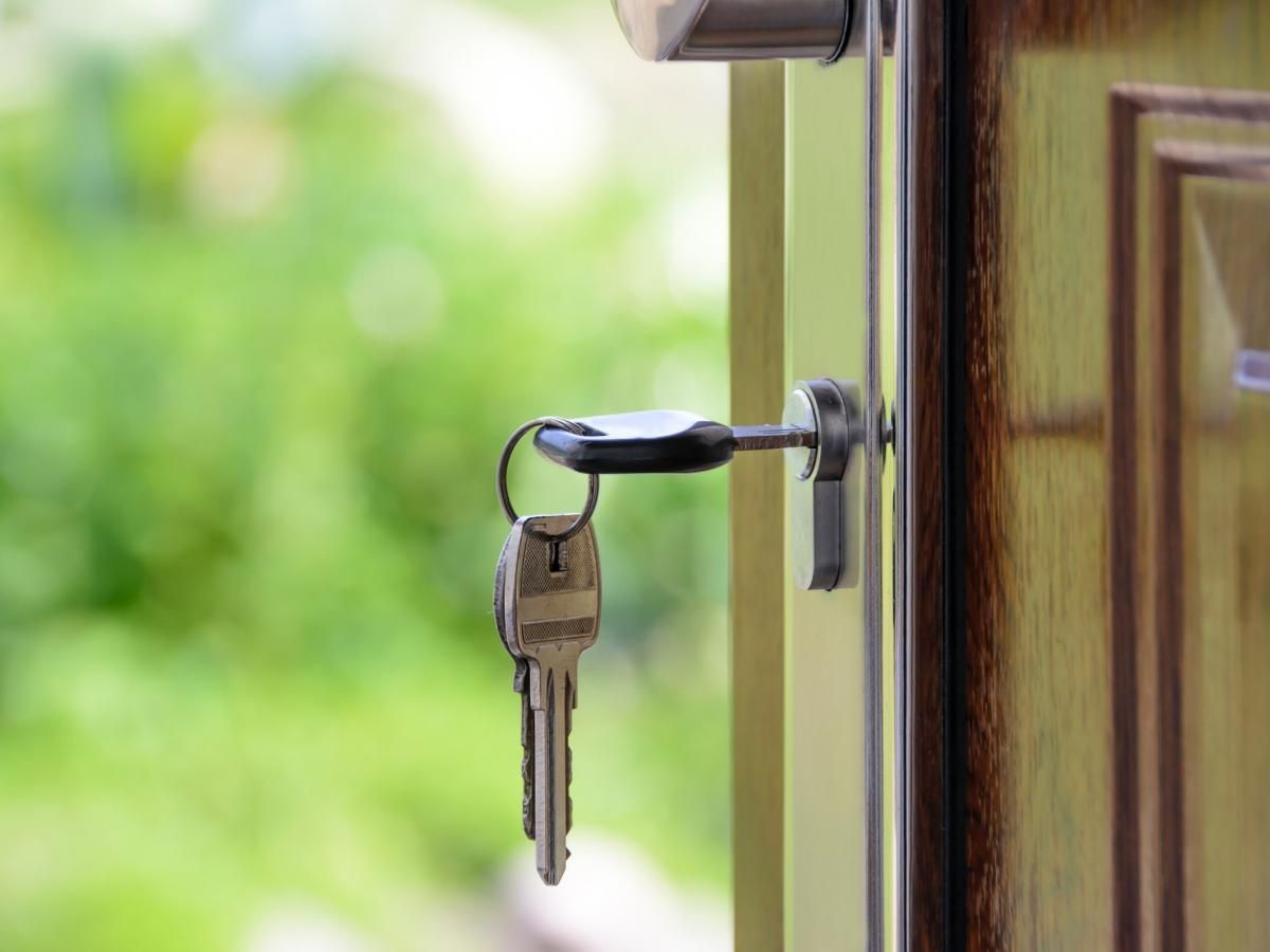 A close up of a door with a key in the lock.