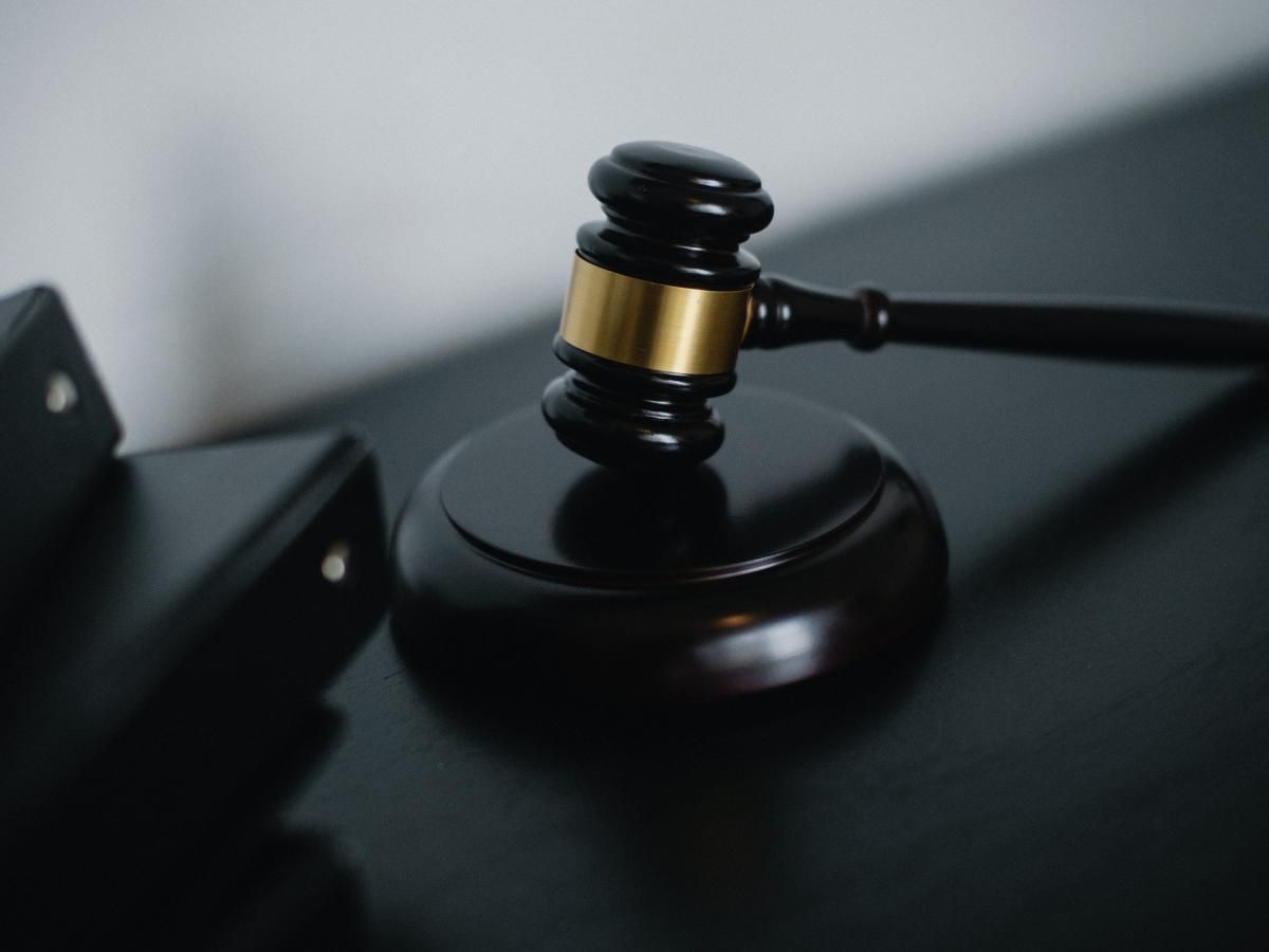 A close up of a judge 's gavel on a table.