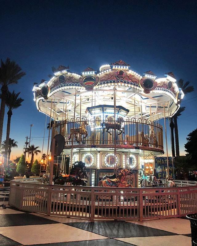 A merry go round is lit up at night