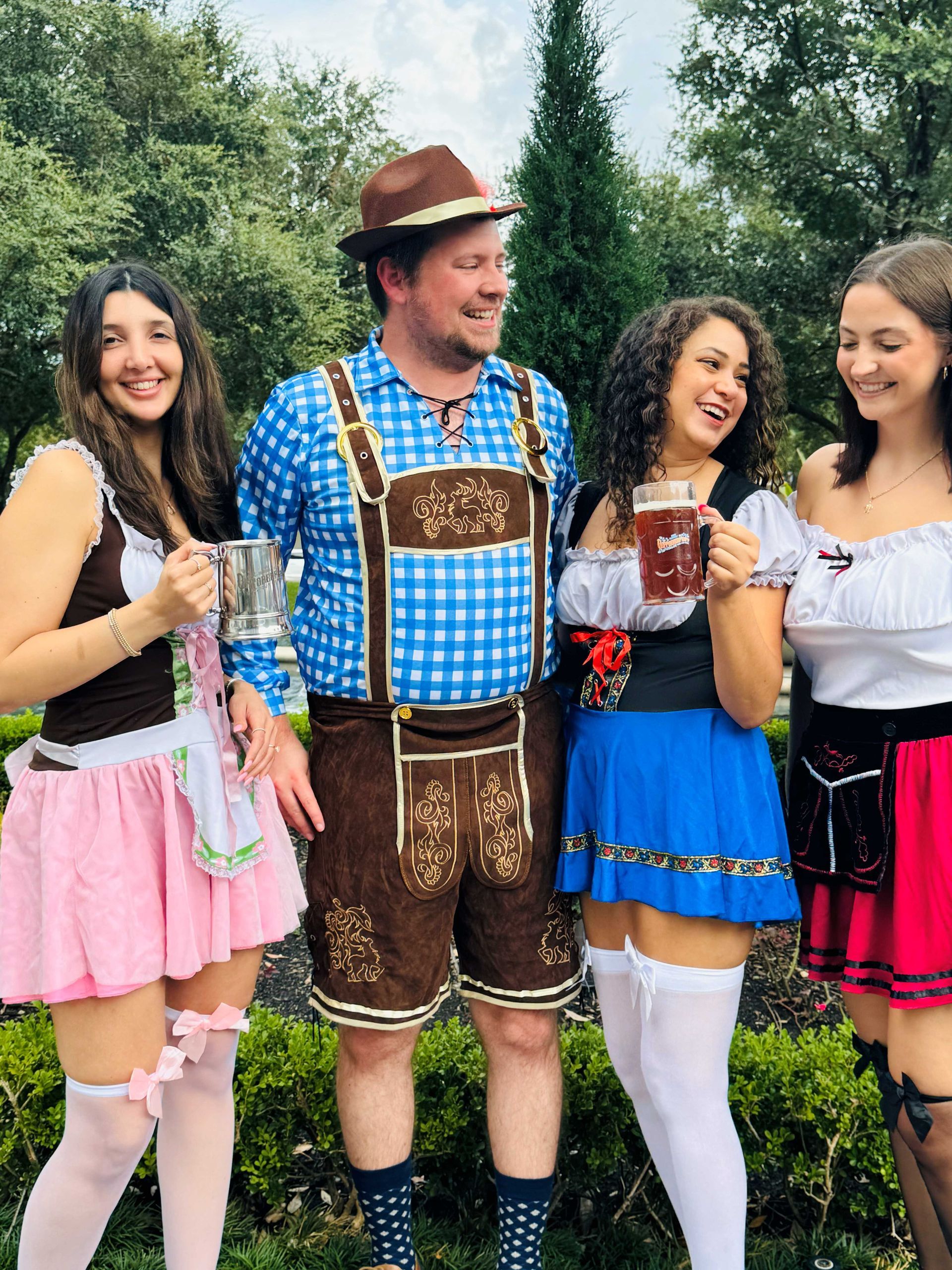 A group of people dressed in oktoberfest costumes are posing for a picture