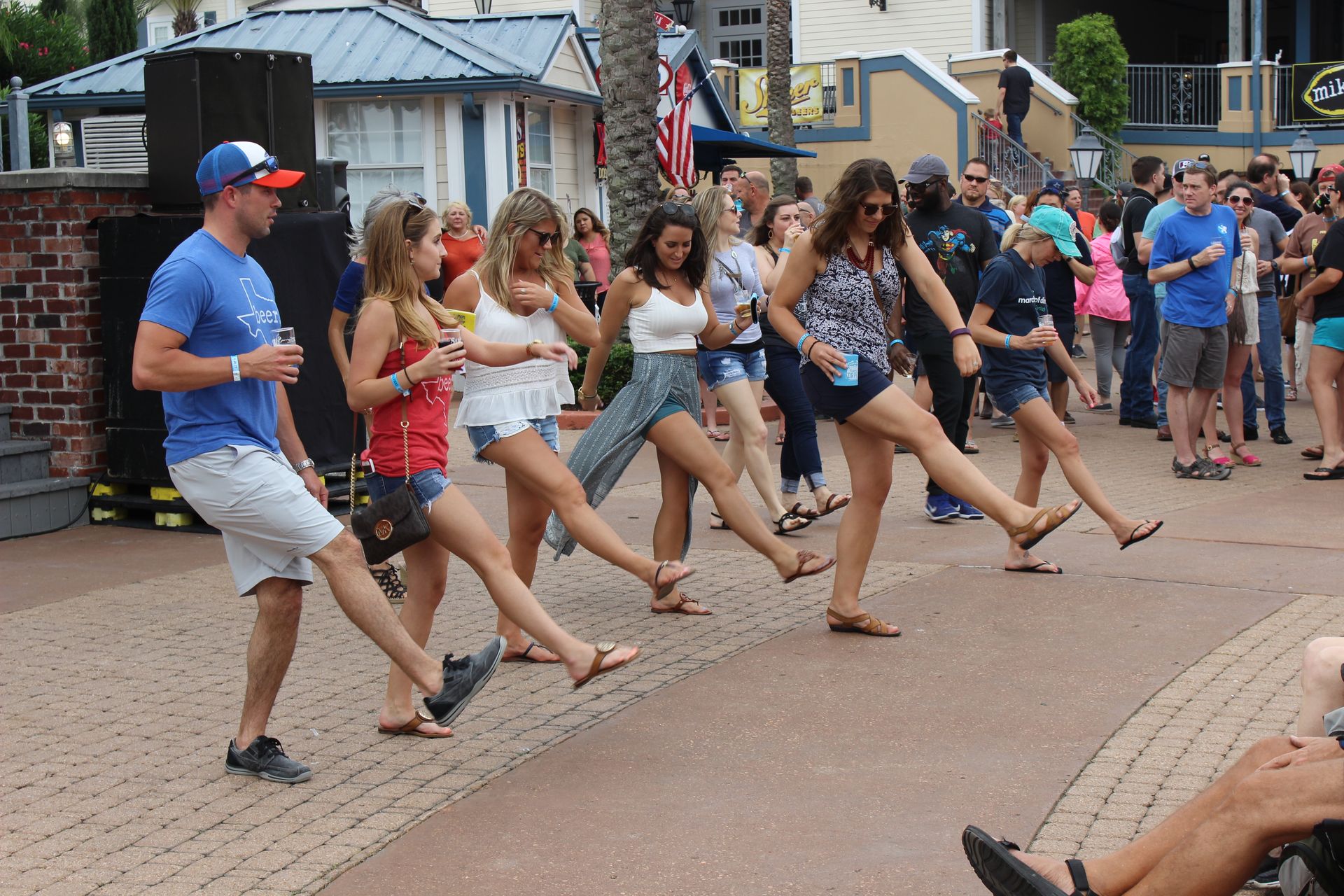 A group of people are dancing in the main plaza