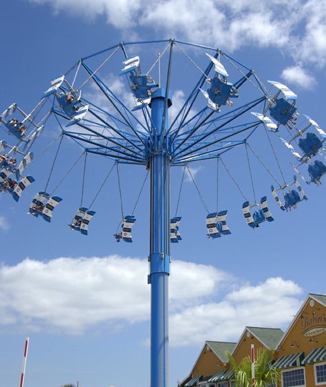 A blue airplane ride with a blue sky in the background
