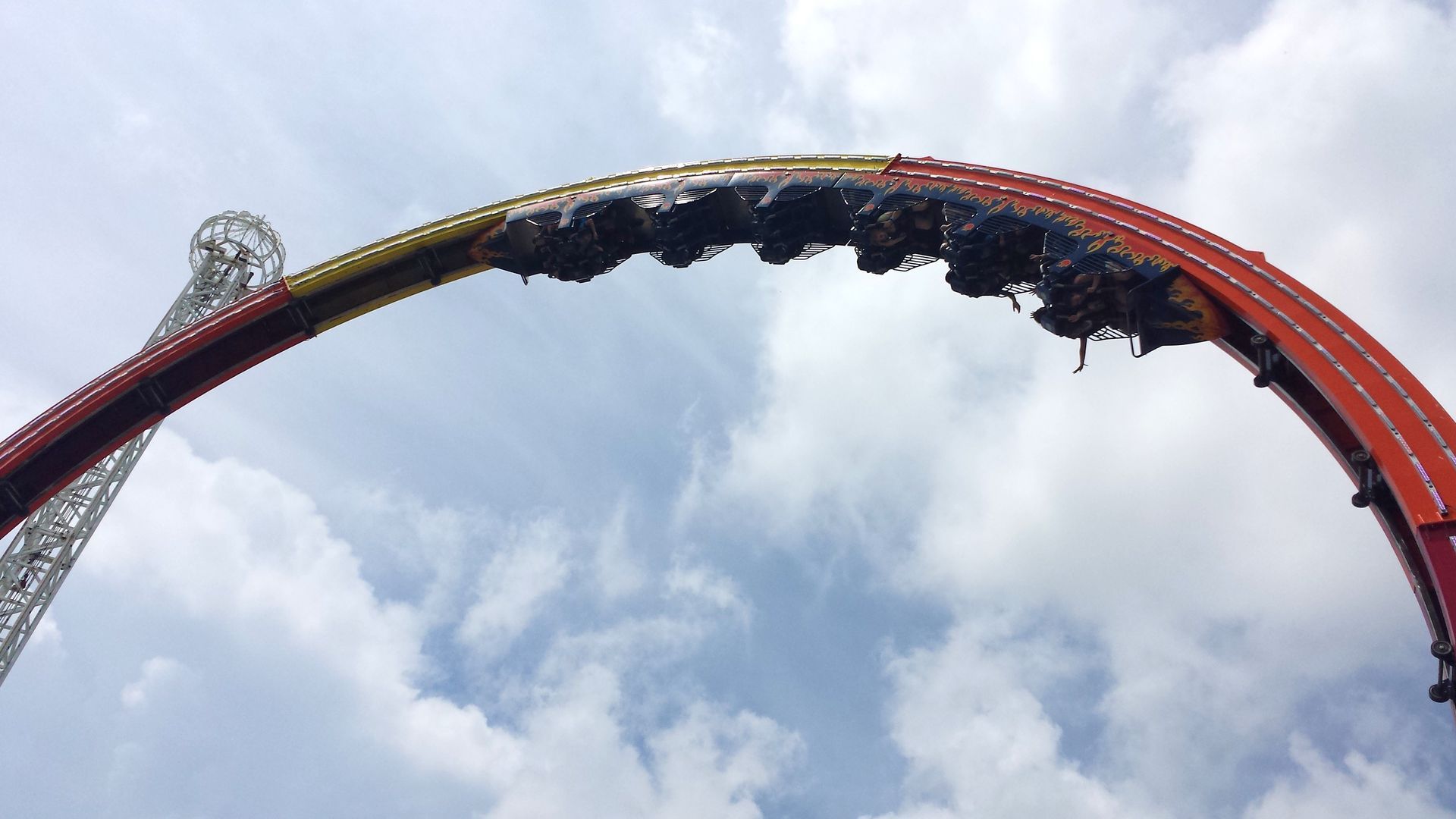 A roller coaster with a blue sky in the background