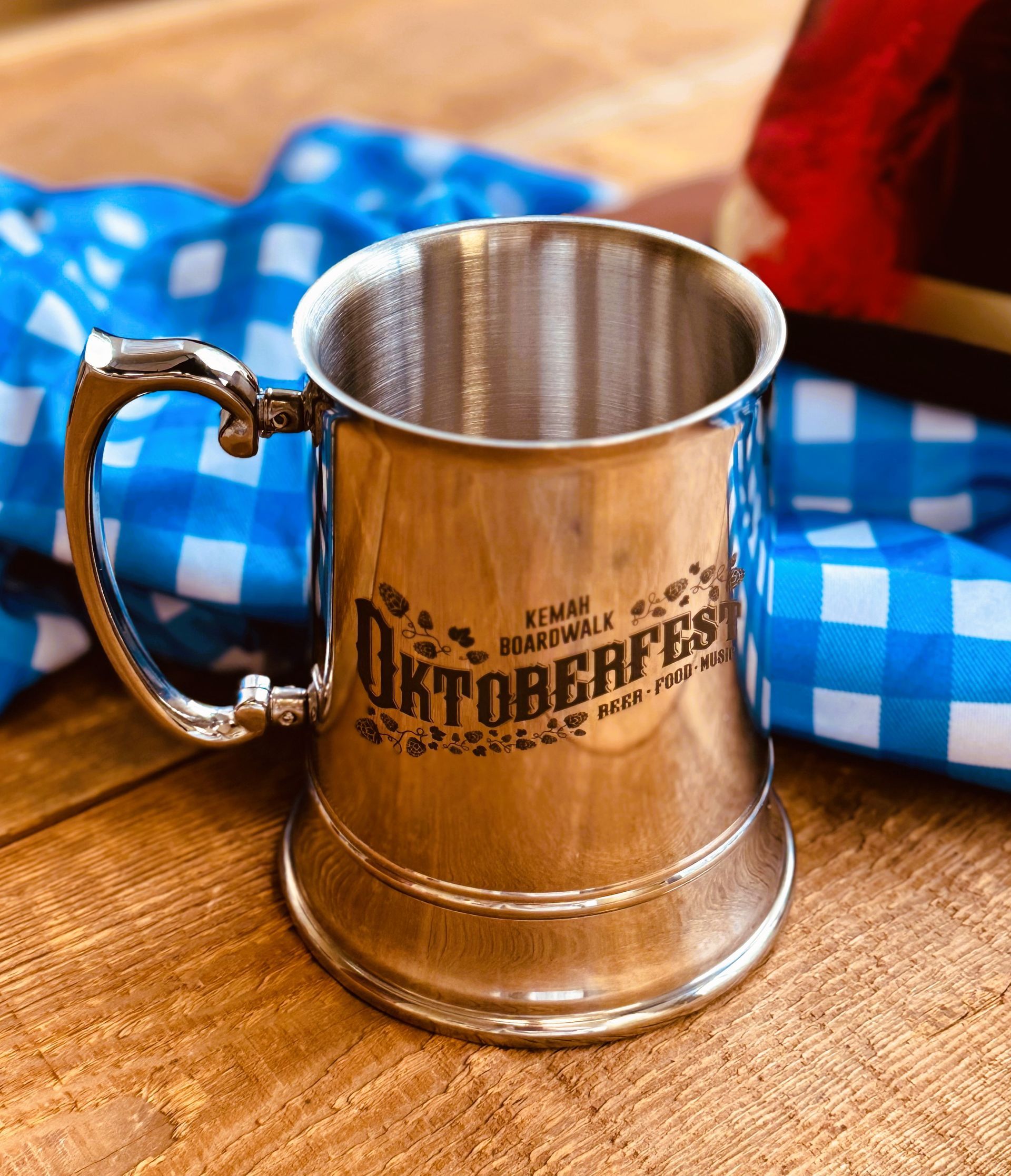 A silver mug that says oktoberfest on it