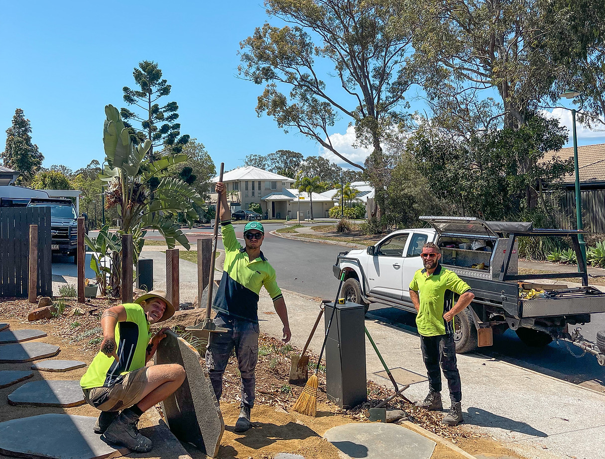 A group of construction workers are standing in front of a white truck.