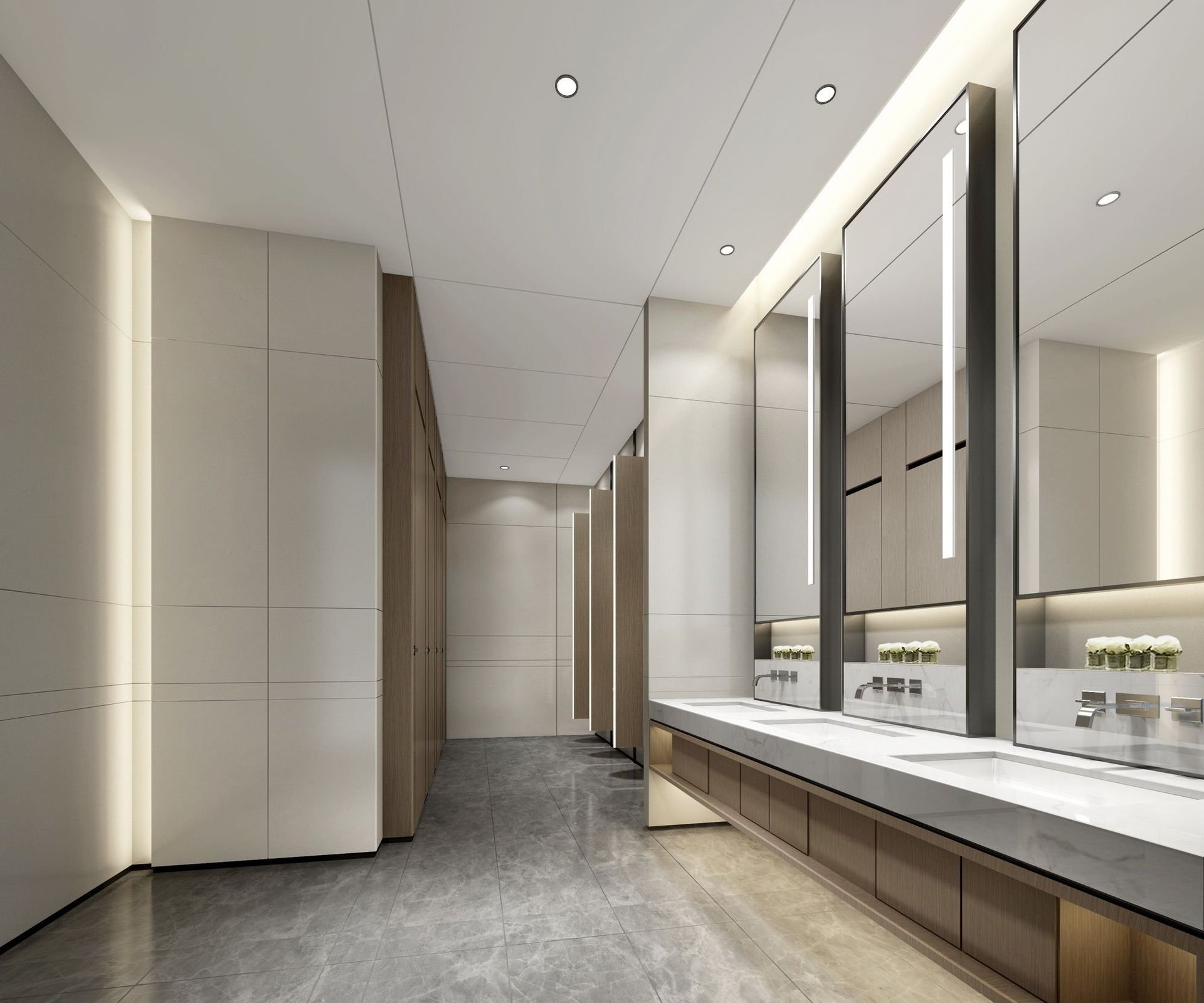 Modern public restroom with marble floor, long vanity, and stalls. Large mirrors reflect the space. Modern public restroom with marble floor, long vanity, and stalls. Large mirrors reflect the space.
