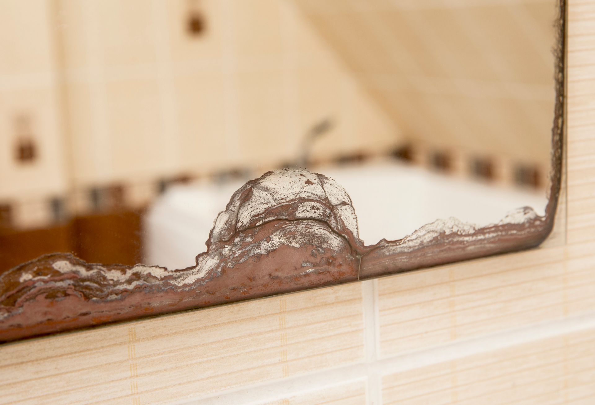 Bathroom mirror with water damage from moist indoors at home. Bathroom mirror with water damage from moist indoors at home.