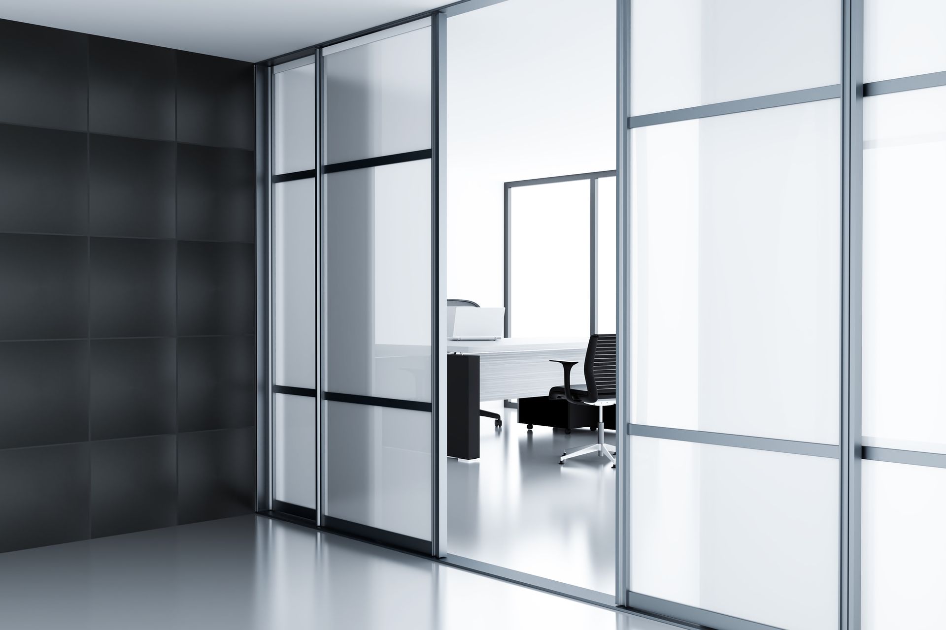 A room with sliding glass doors leading to a desk and chair.