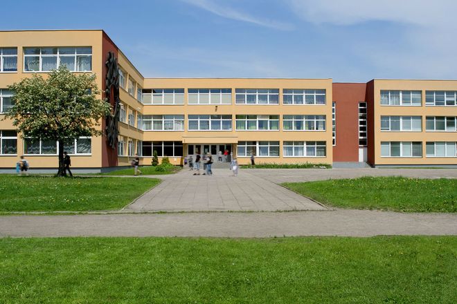 A large building with a lot of windows and a tree in front of it