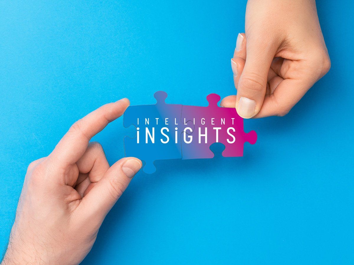 Hands holding Intelligent Insights puzzle pieces