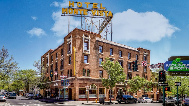 The hotel monte vista is located on the corner of a city street in flagstaff